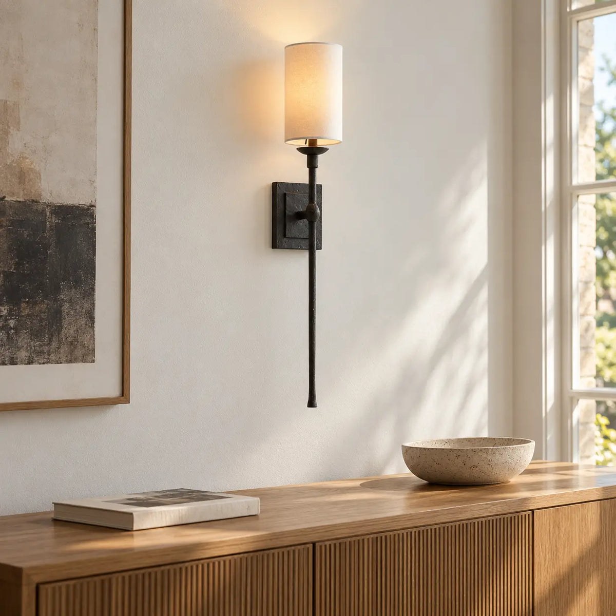 Black fabric shade wall light above a living room sideboard
