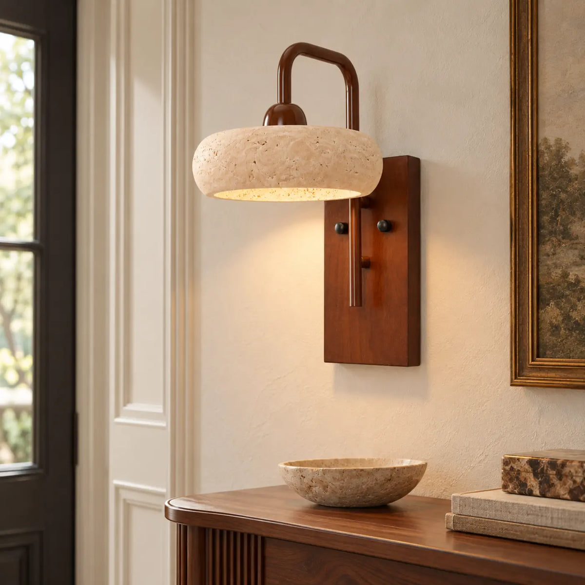 Rounded travertine and walnut wall light in a bright British entryway