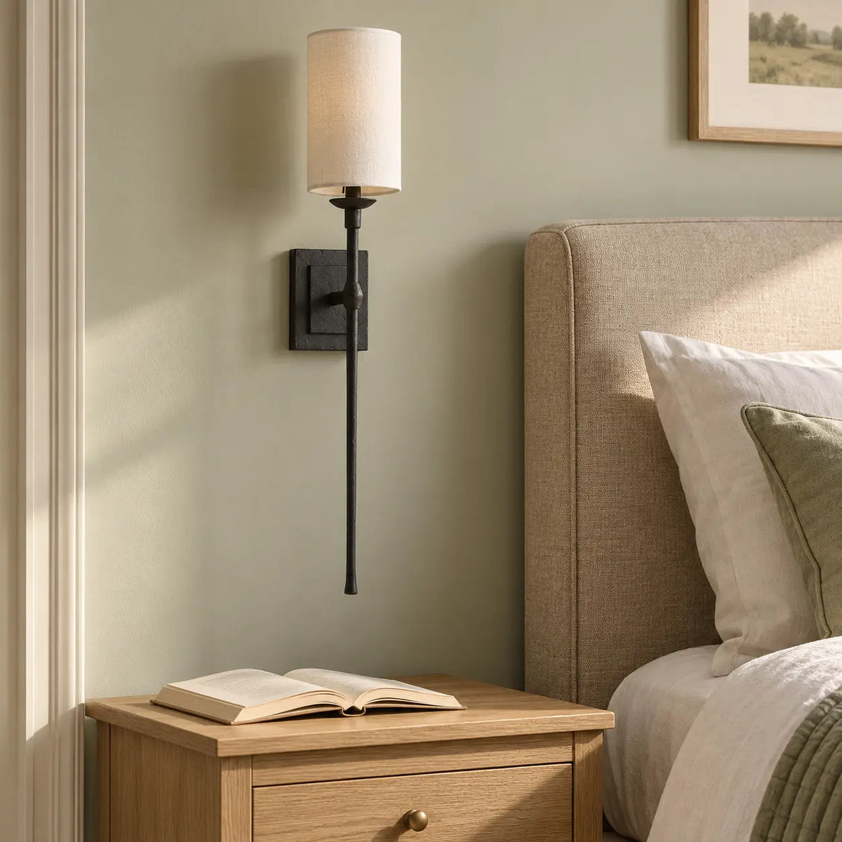 Black metal wall light beside a bedroom bedside table