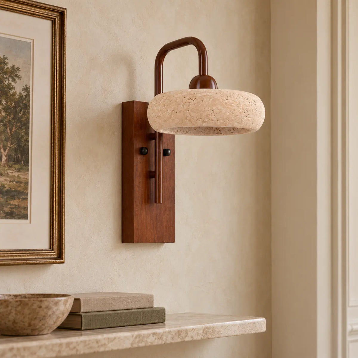 Rounded travertine wall light with walnut base in a warm hallway