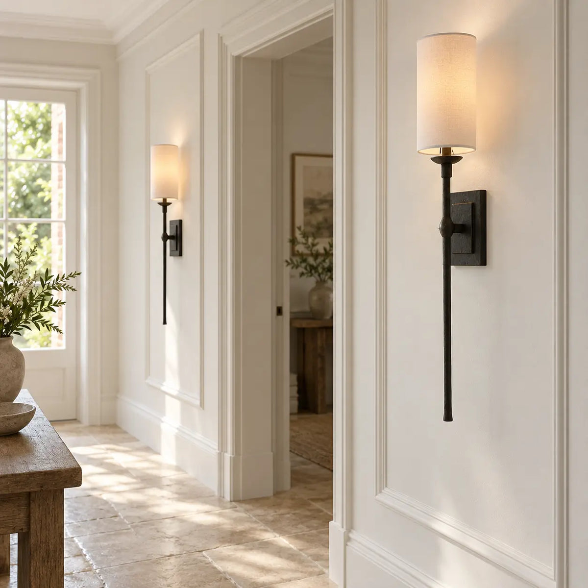 Pair of black fabric wall lights in a bright hallway