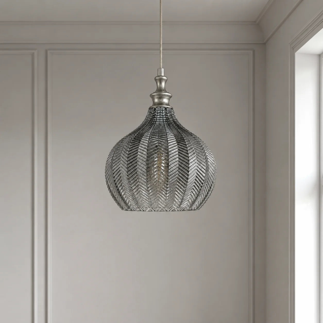 Solenne round smoke grey chevron glass pendant light in a modern British interior