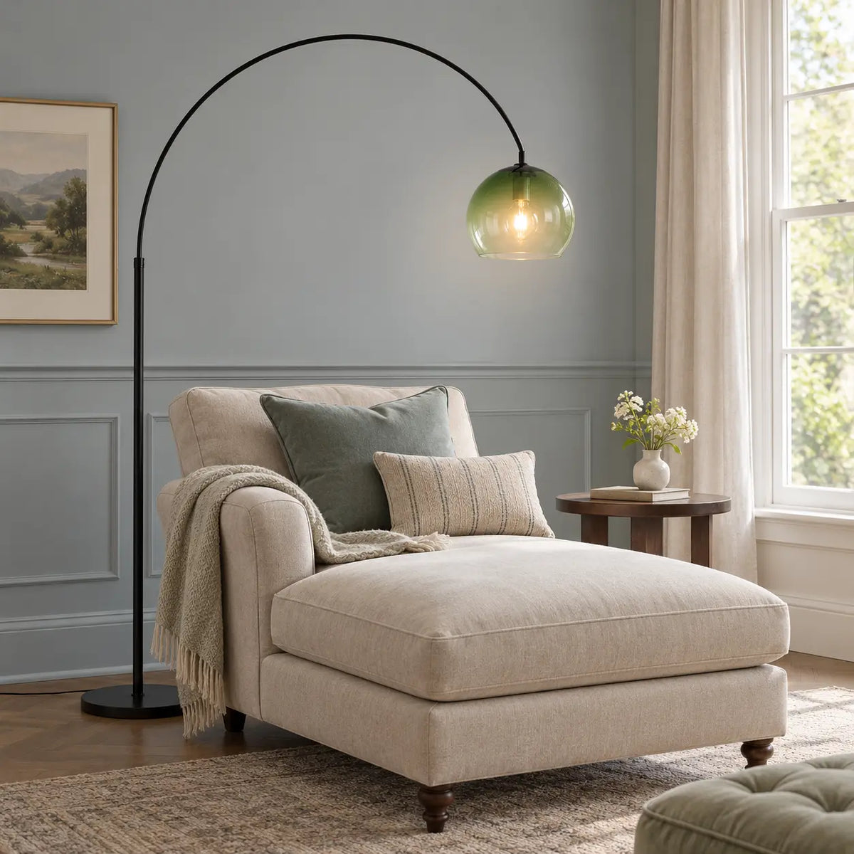 Gradient green glass floor lamp beside a chaise