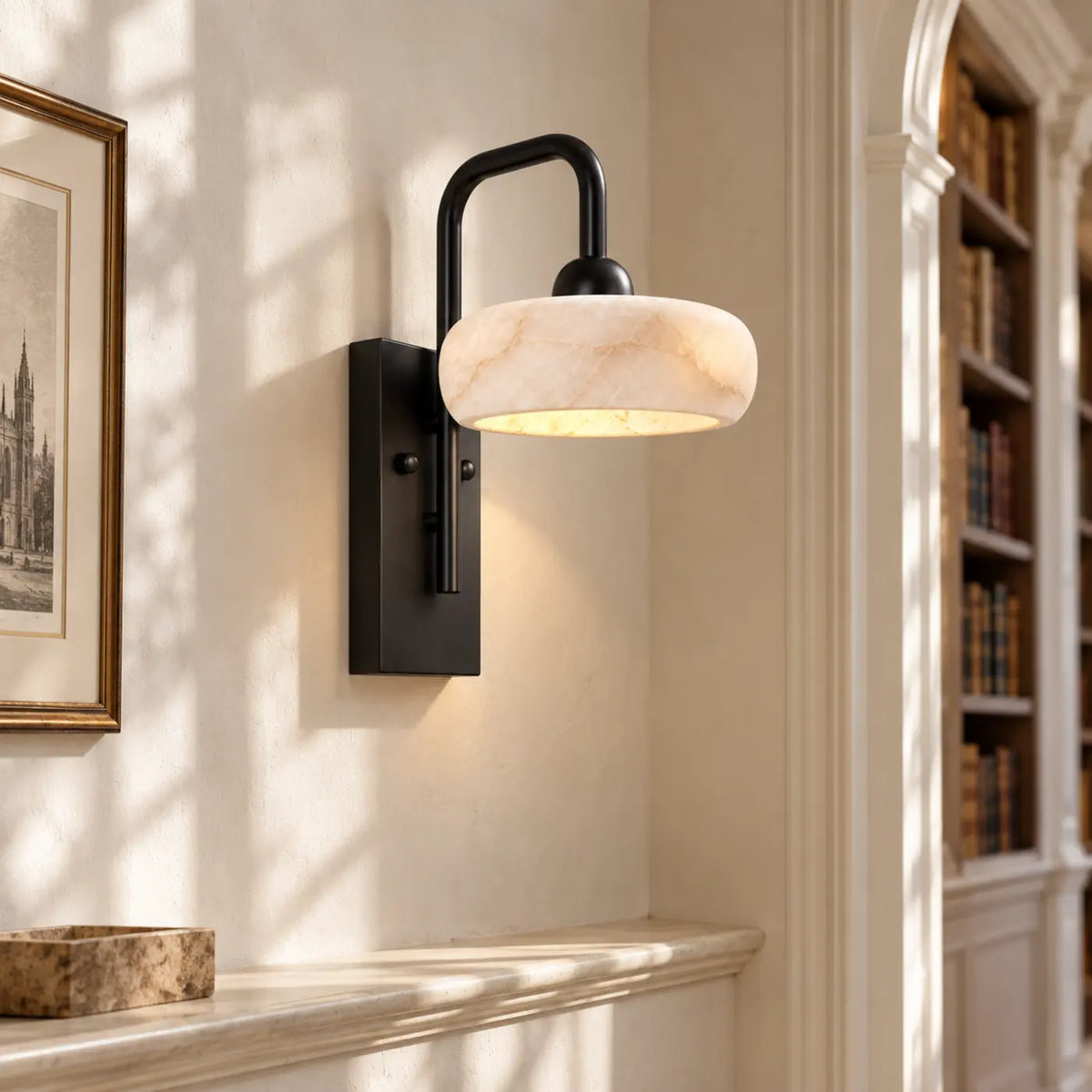 Rounded alabaster wall light with black metal base in a library corridor
