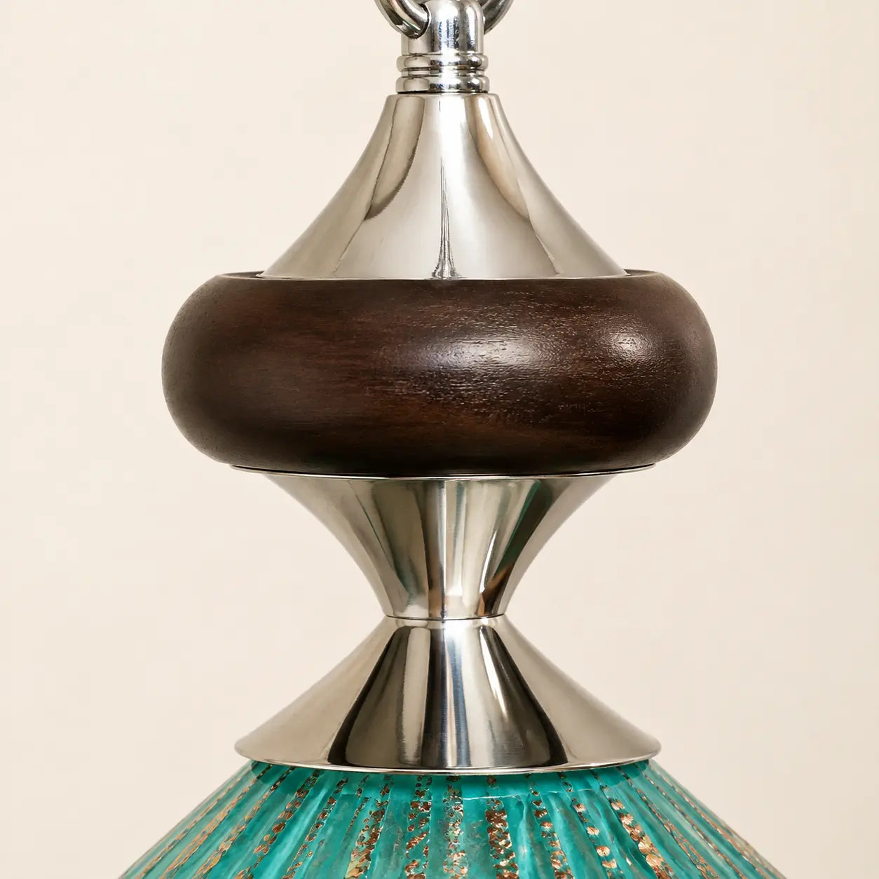 Close detail of walnut wood and silver-tone metal pendant fitting