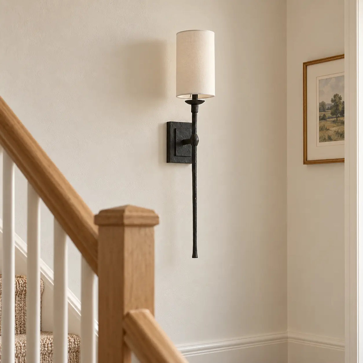Slim black wall light on a stair landing wall