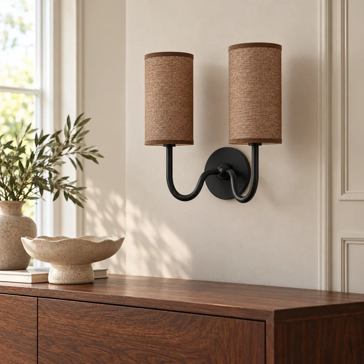 Black double wall light with coffee linen shade in a British interior