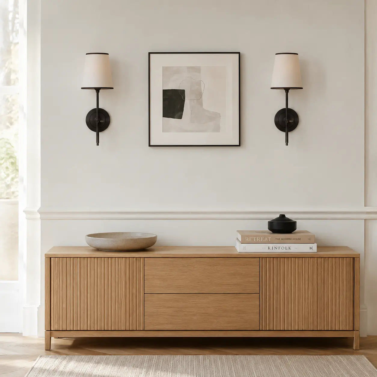 Pair of black linen shade wall lights above a living room console