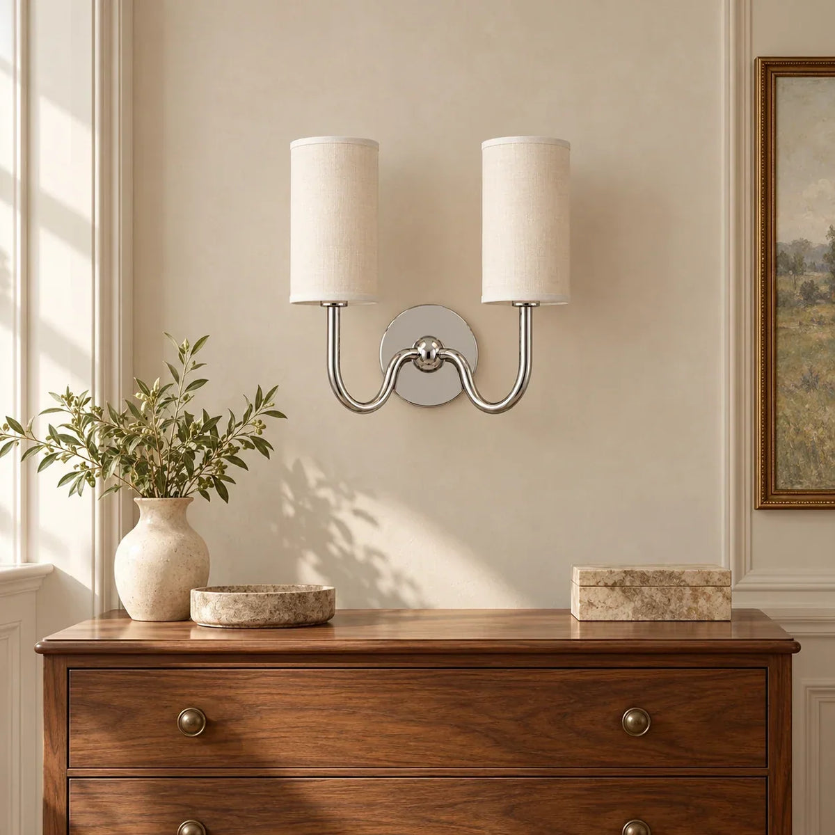 Chrome double wall light with white linen shade in a British interior