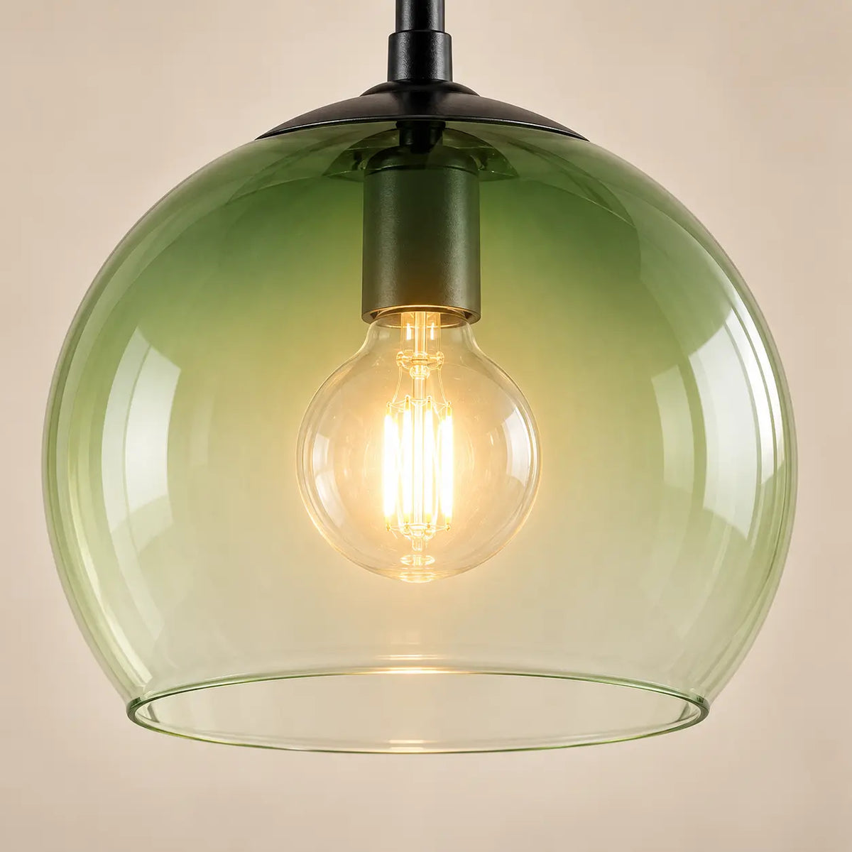 Close detail of the green gradient glass globe and bulb