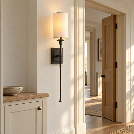 Black fabric wall light beside a hallway doorway