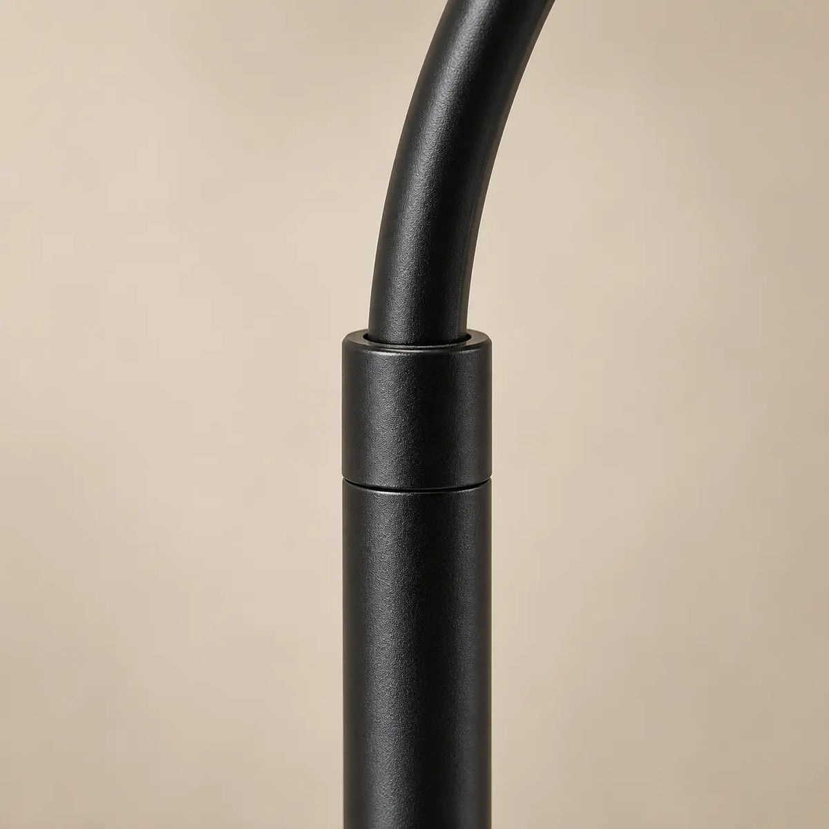 Close detail of the adjustable black metal floor lamp stem