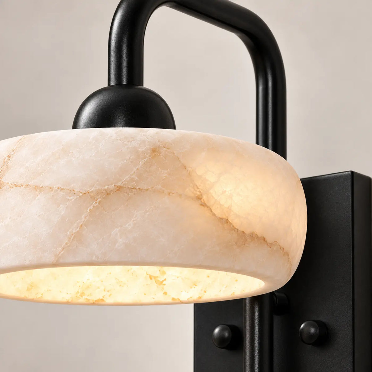 Close-up of veined alabaster and matte black metal details