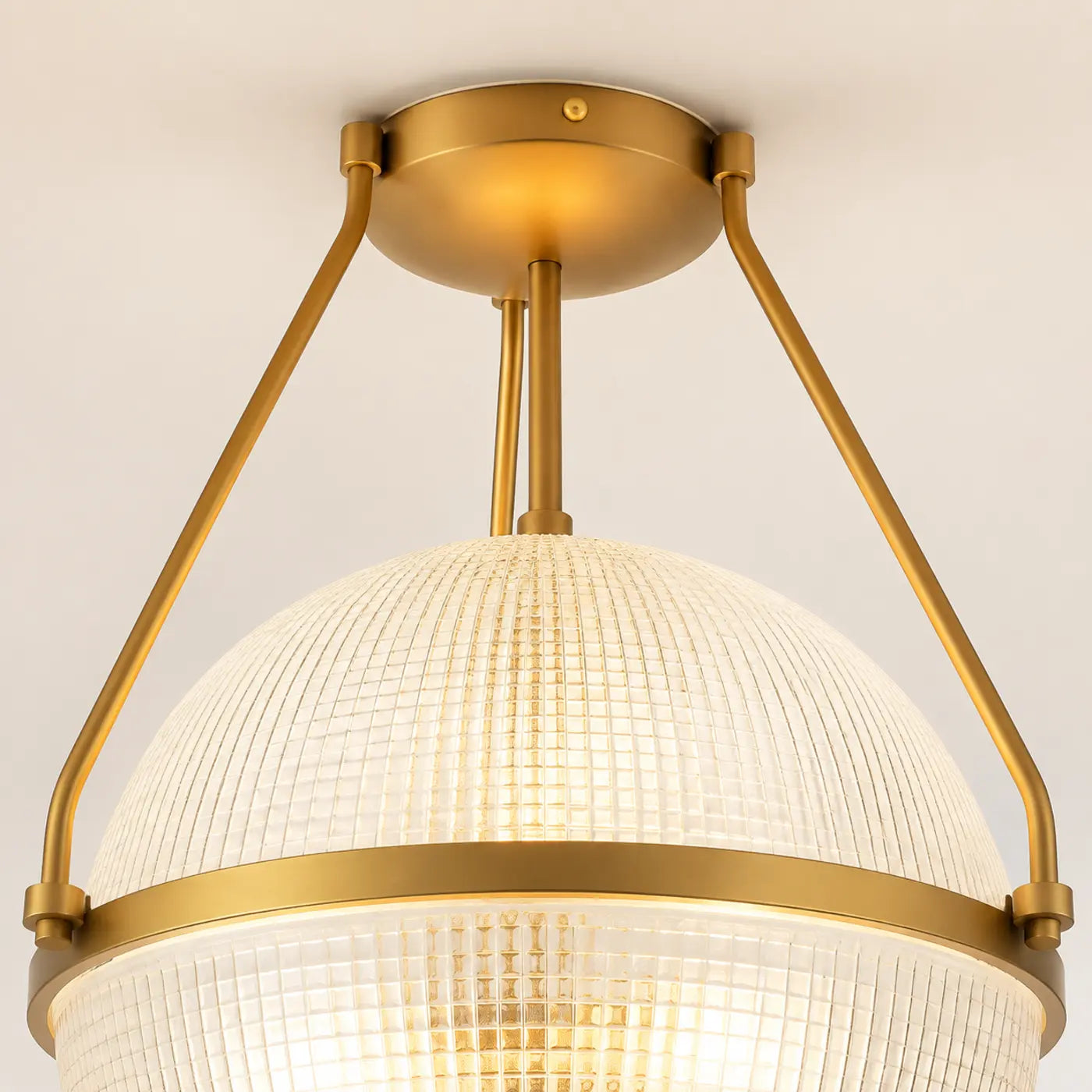 Gold canopy and three-rod ceiling light frame detail