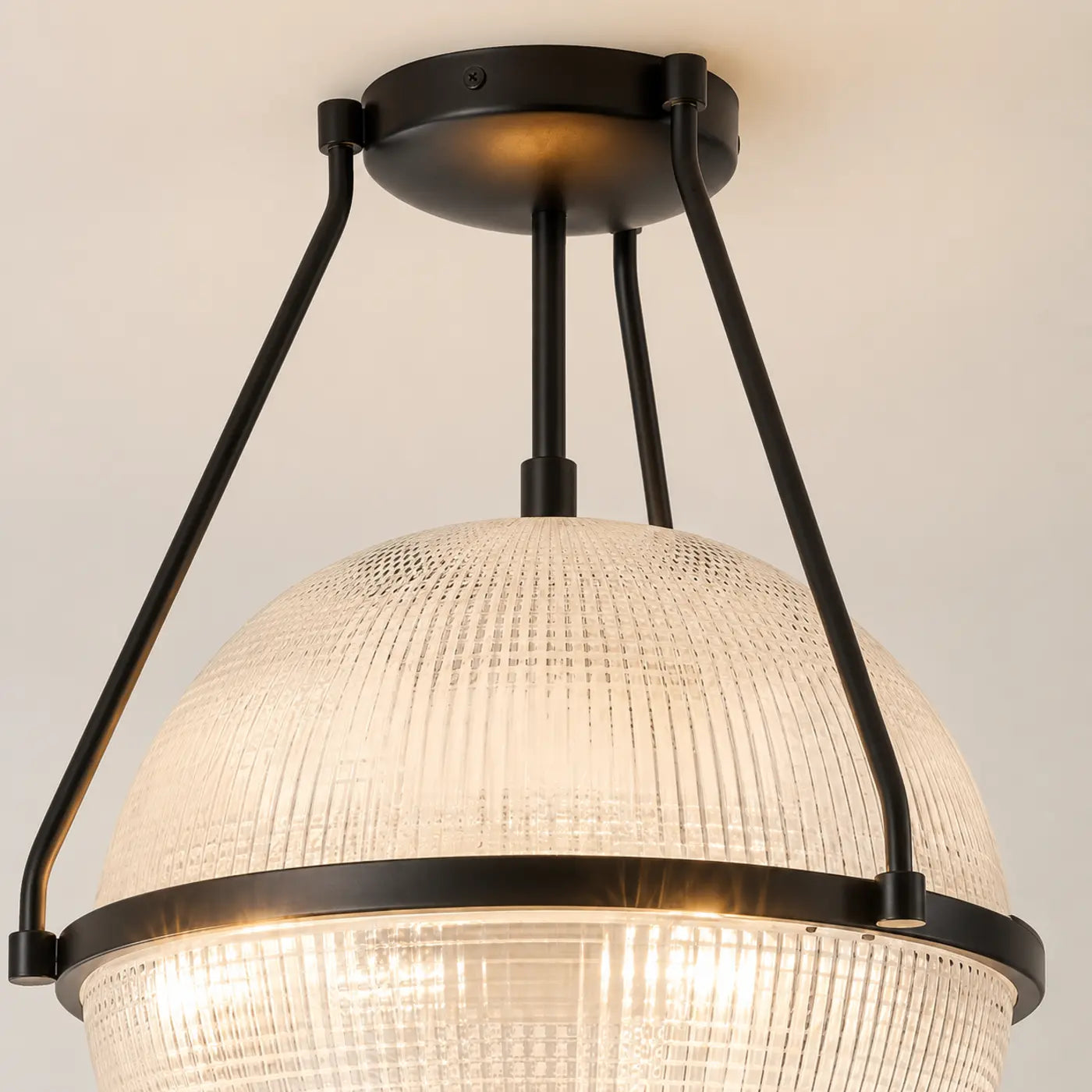 Black canopy and three-rod ceiling light frame detail