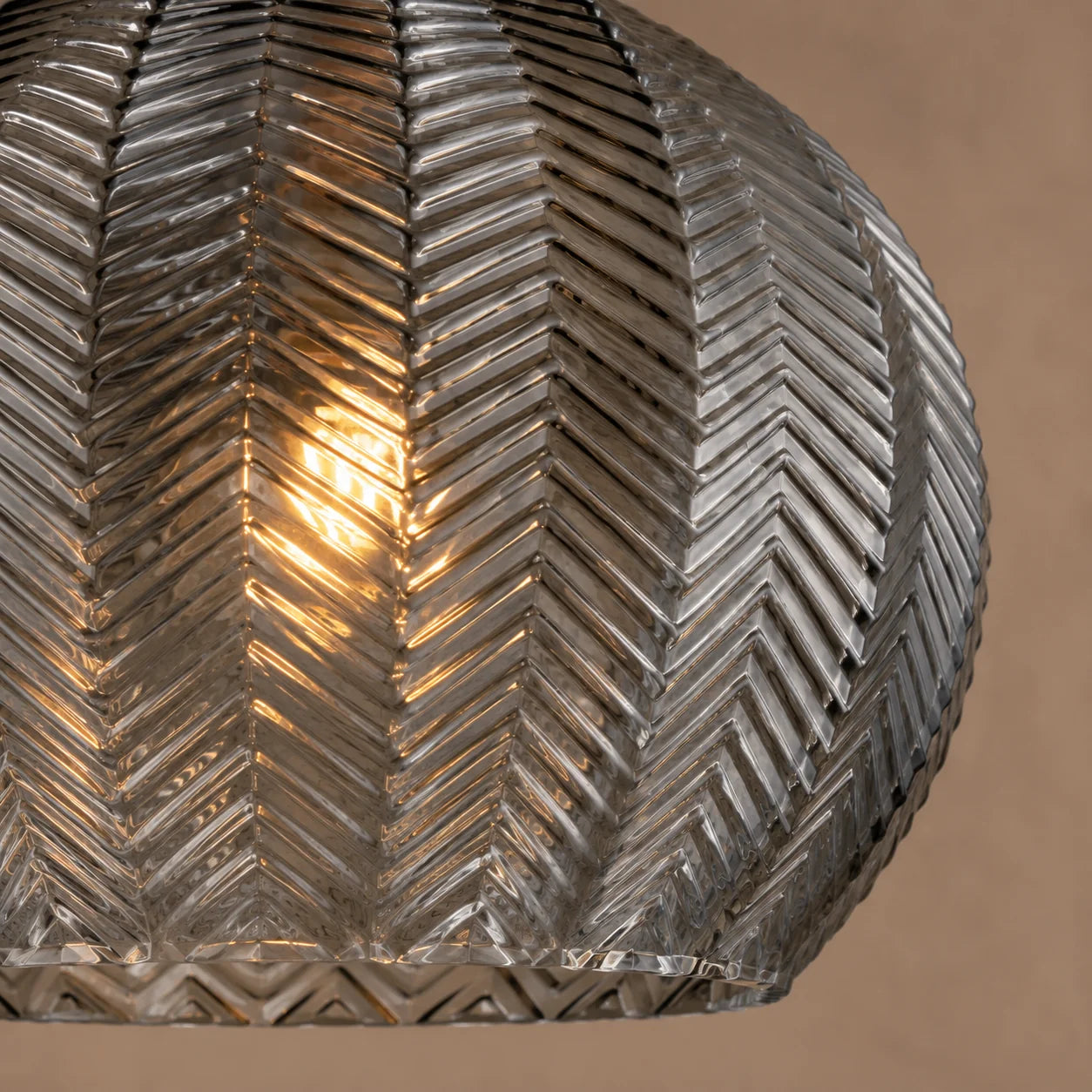 Close-up of smoke grey textured glass and central bulb