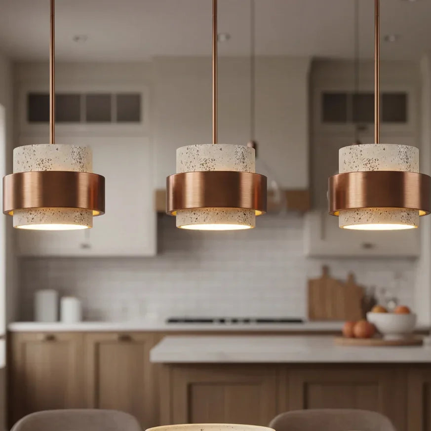 Travertine and walnut cylinder pendant lights above a kitchen island