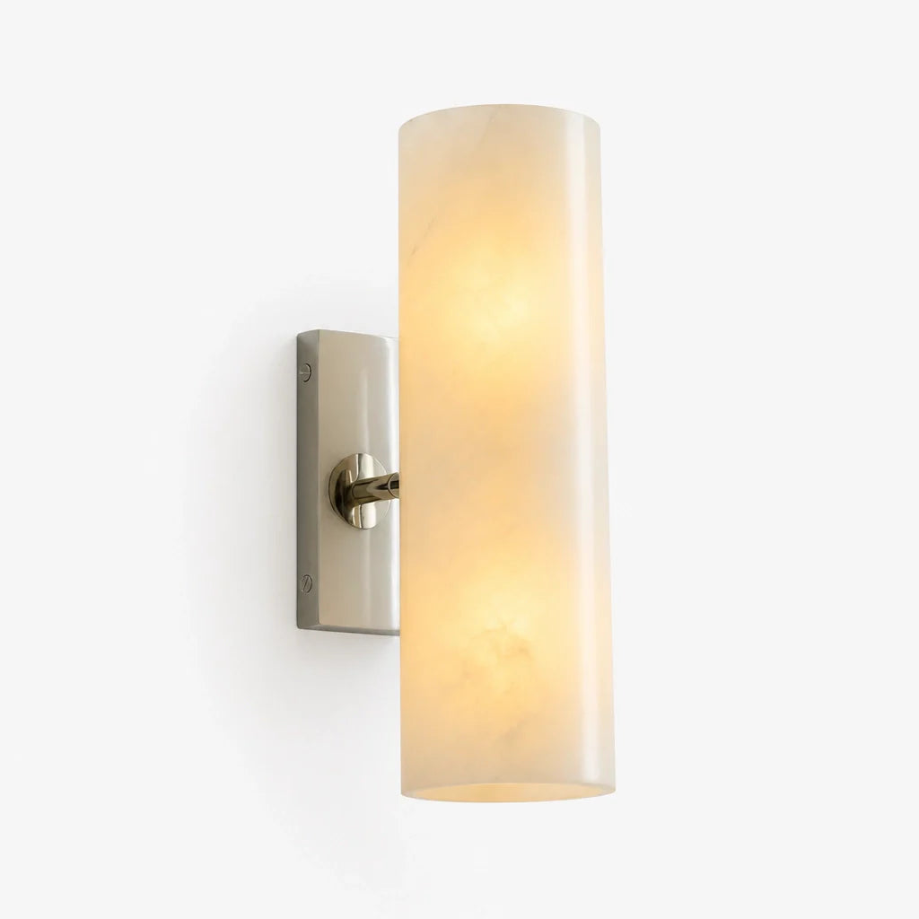 Wall-mounted light fixture with a cylindrical glass shade on a white background