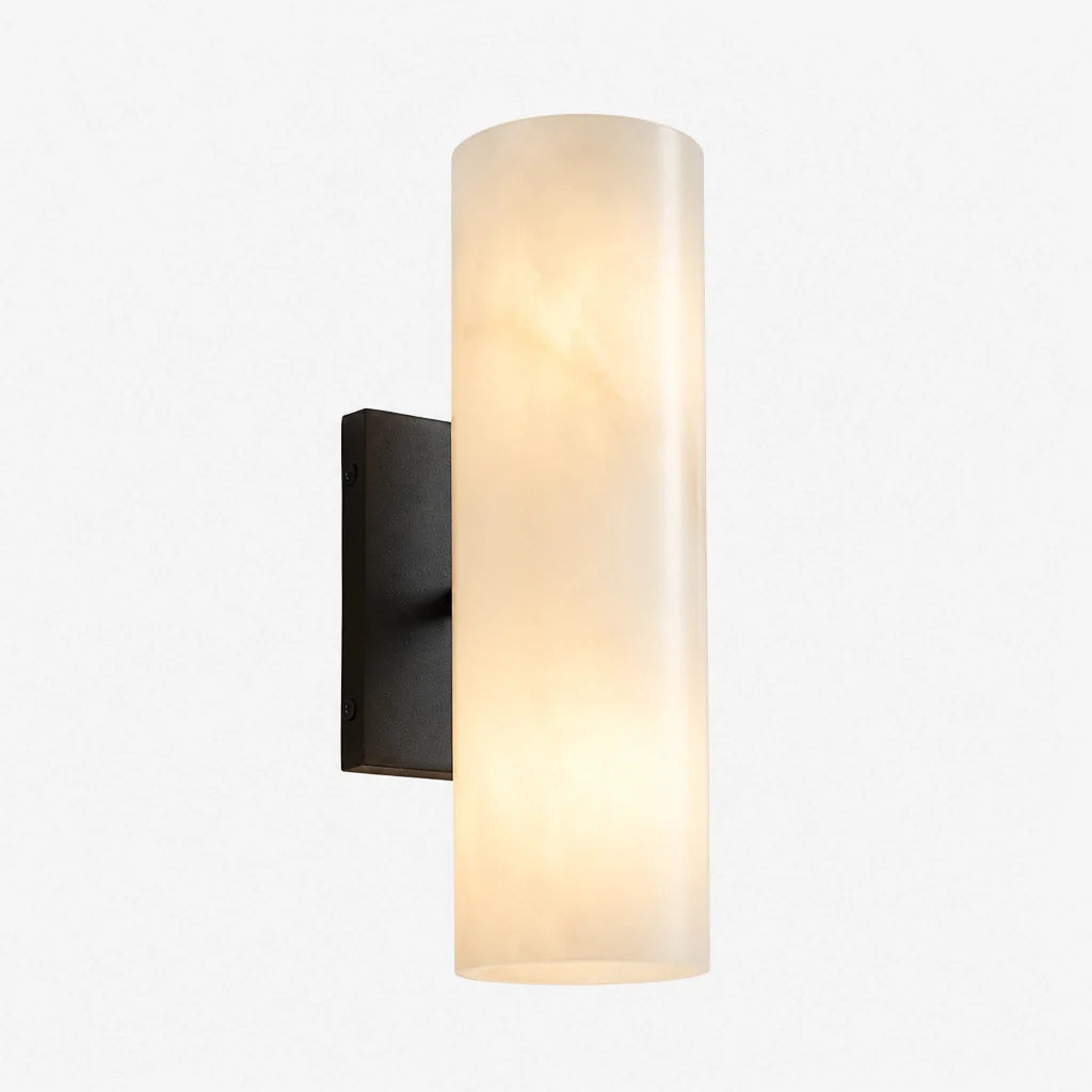 Wall-mounted light fixture with a cylindrical glass shade on a white background