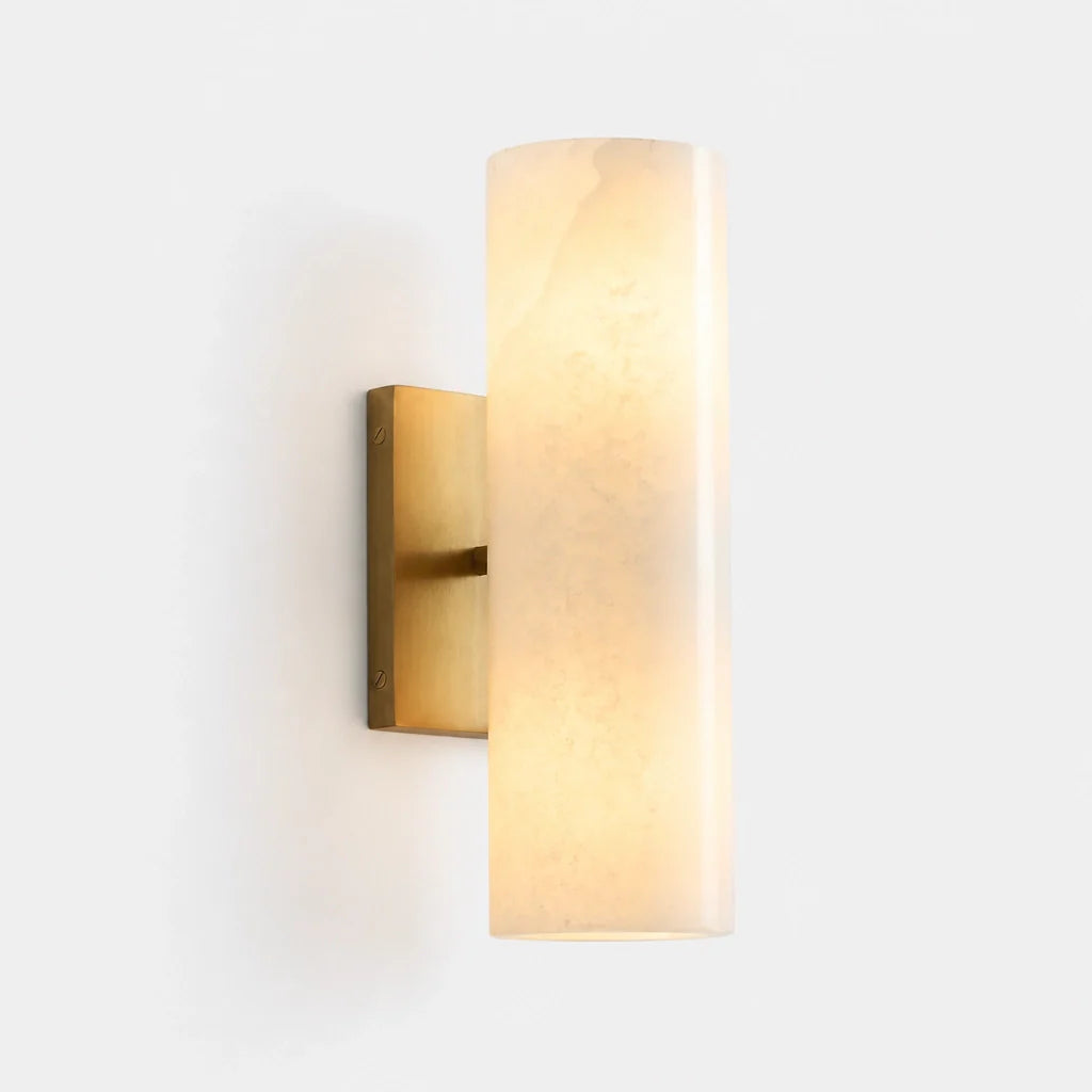 Wall-mounted light fixture with cylindrical glass shade on a white background