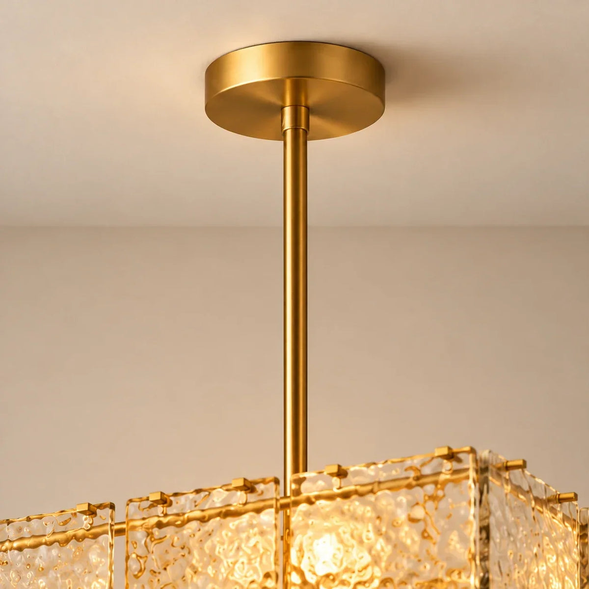 Gold suspension rod and upper textured glass frame close-up