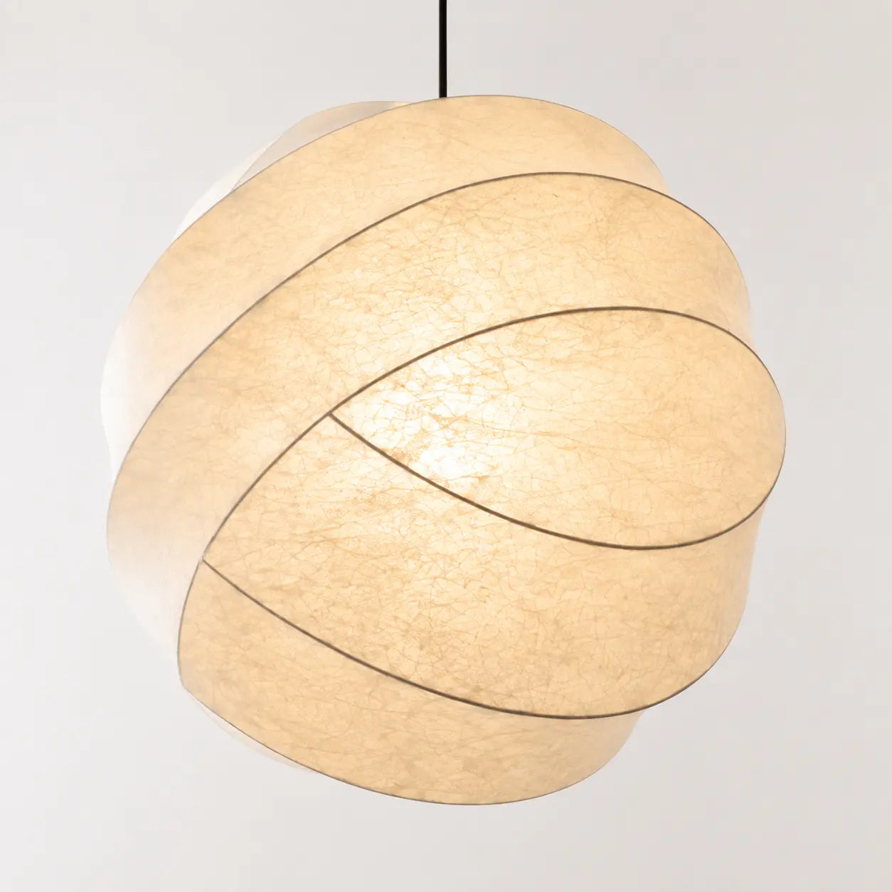 Close detail of warm light diffusing through overlapping cocoon fibre ribbons