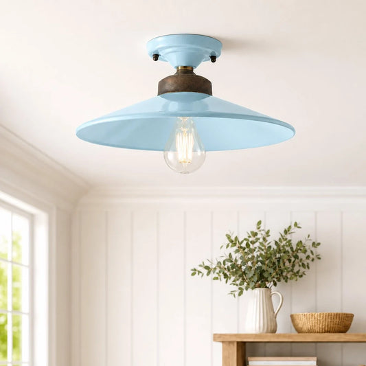 Ceiling light fixture with a blue shade in a room with a window and wooden table.