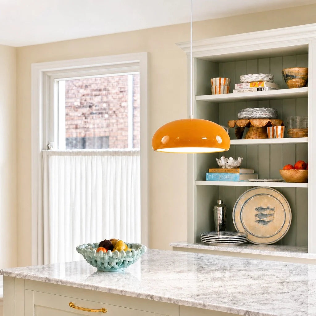 Kitchen with marble countertop, window, and shelves with decorative items.