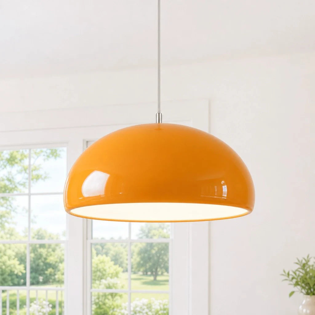 Orange pendant light hanging in a room with a window view