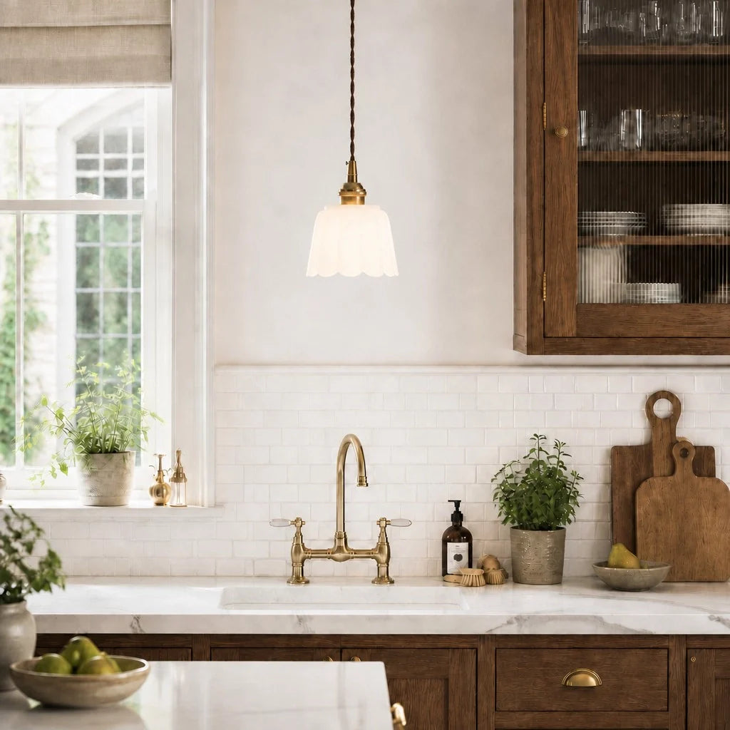Modern kitchen with wooden cabinets, white countertops, and a brass faucet.