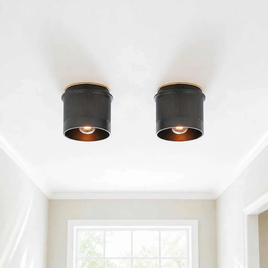 Two black ceiling lights on a white ceiling with a window in the background.