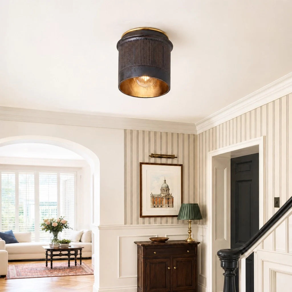 Decorative ceiling light fixture in a home interior with striped walls and a painting.