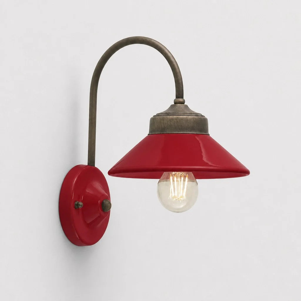 Red wall sconce with a lit bulb on a light gray background