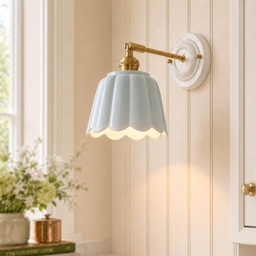 Wall-mounted light fixture with a decorative shade in a room with a window and plants.