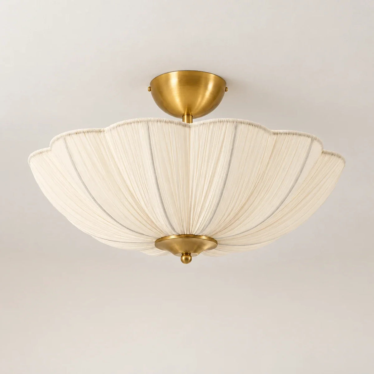 Soft ivory pleated flower semi flush ceiling light on a warm neutral studio background