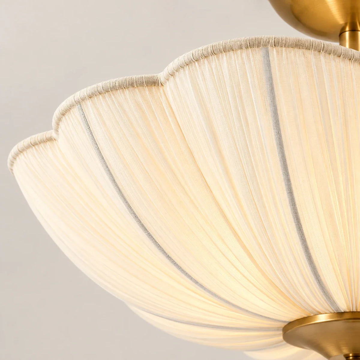 Close-up of ivory scalloped fabric pleats