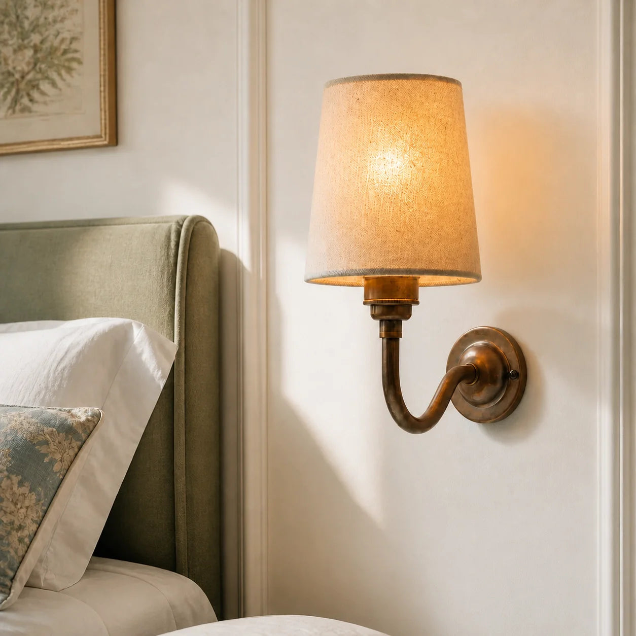 Natural cotton shade wall light beside a bed