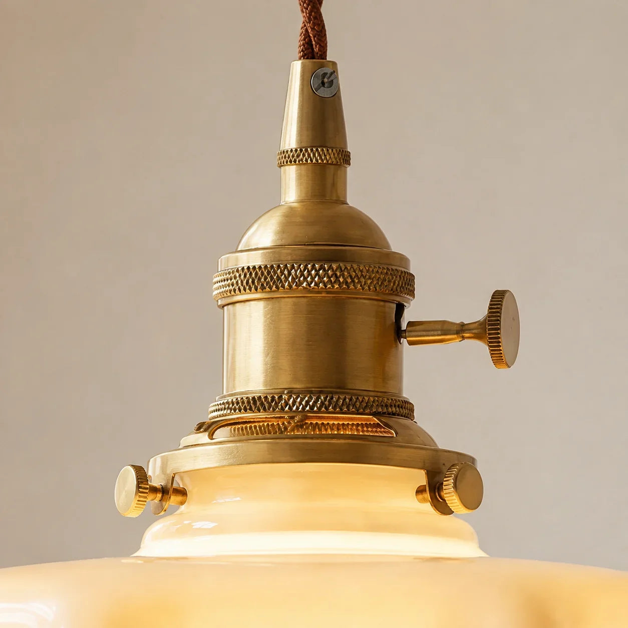 Sharp close-up of the Elowen antique brass lampholder and shade retaining screws