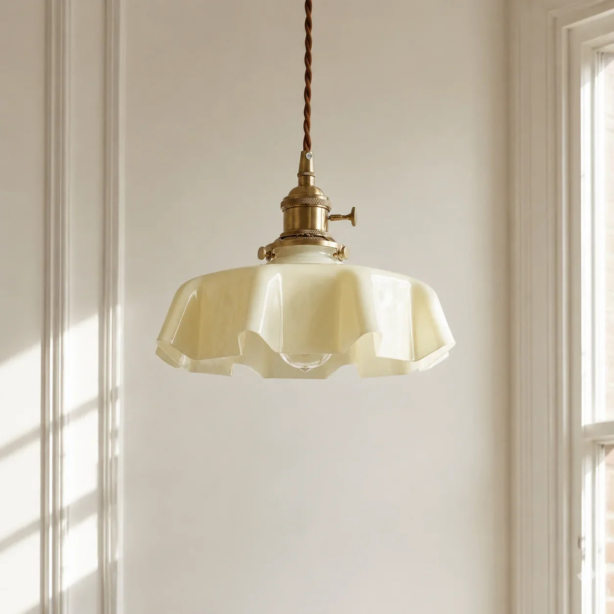 Cream Elowen scalloped opaline glass pendant light in a simple modern British interior