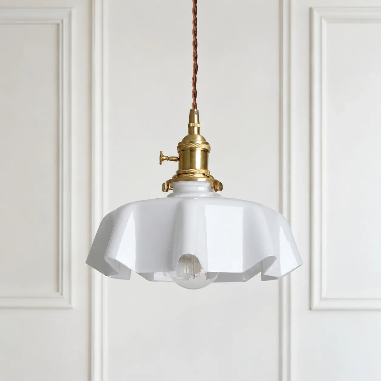 White Elowen scalloped opaline glass pendant light in a panelled modern British interior