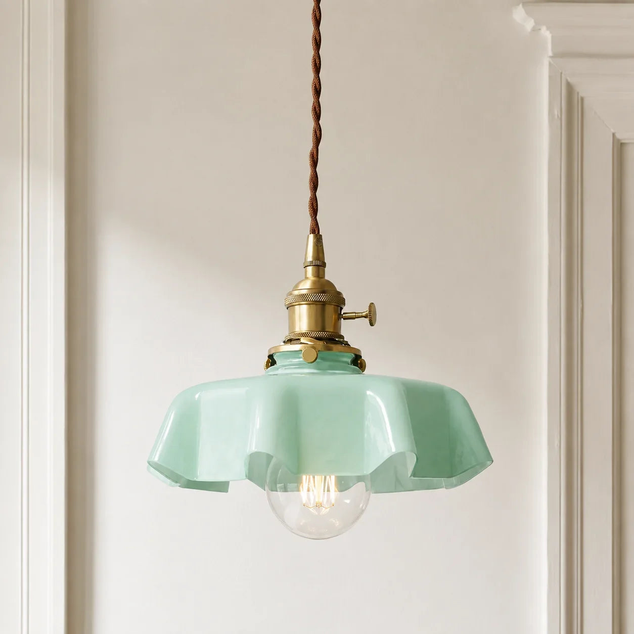 Spring green Elowen scalloped opaline glass pendant light in a modern British hallway