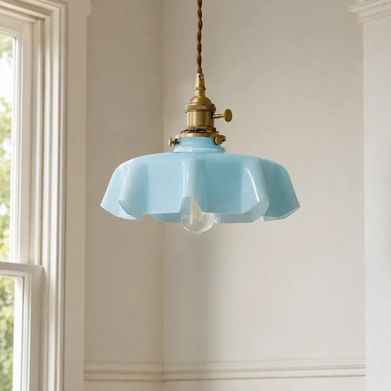 Soft blue Elowen scalloped opaline glass pendant light in a bright British interior