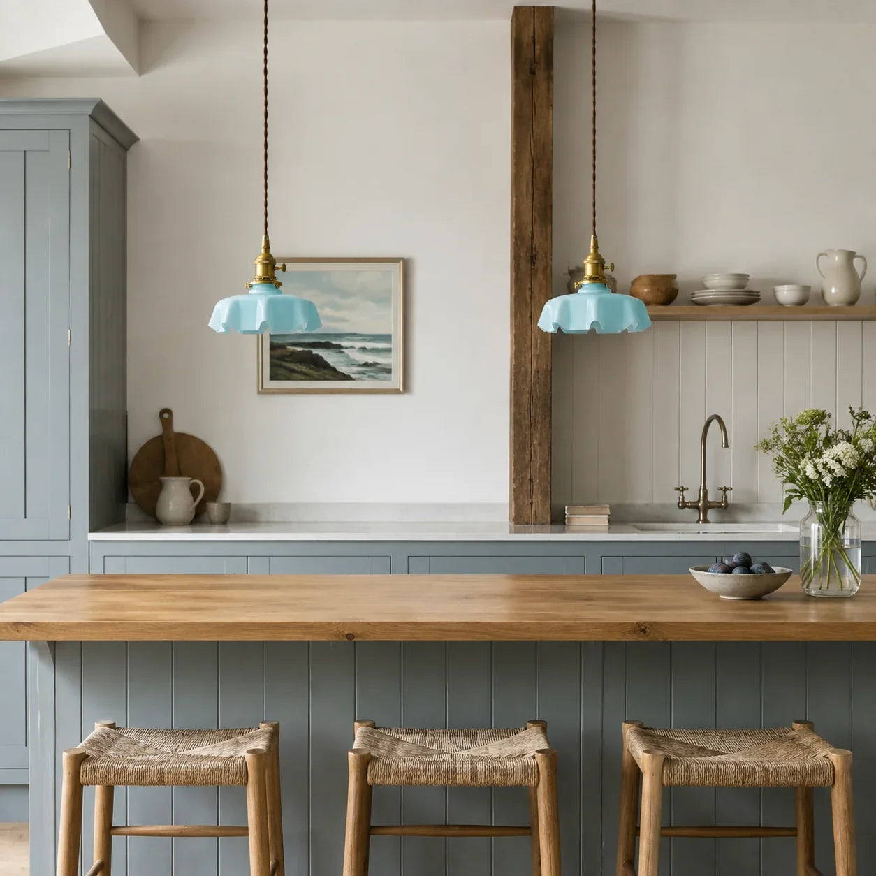 Pair of soft blue Elowen pendant lights above an oak breakfast bar