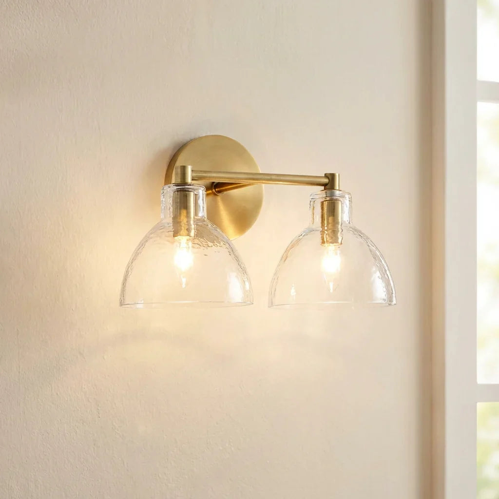 Antique brass wall light with two clear glass shades