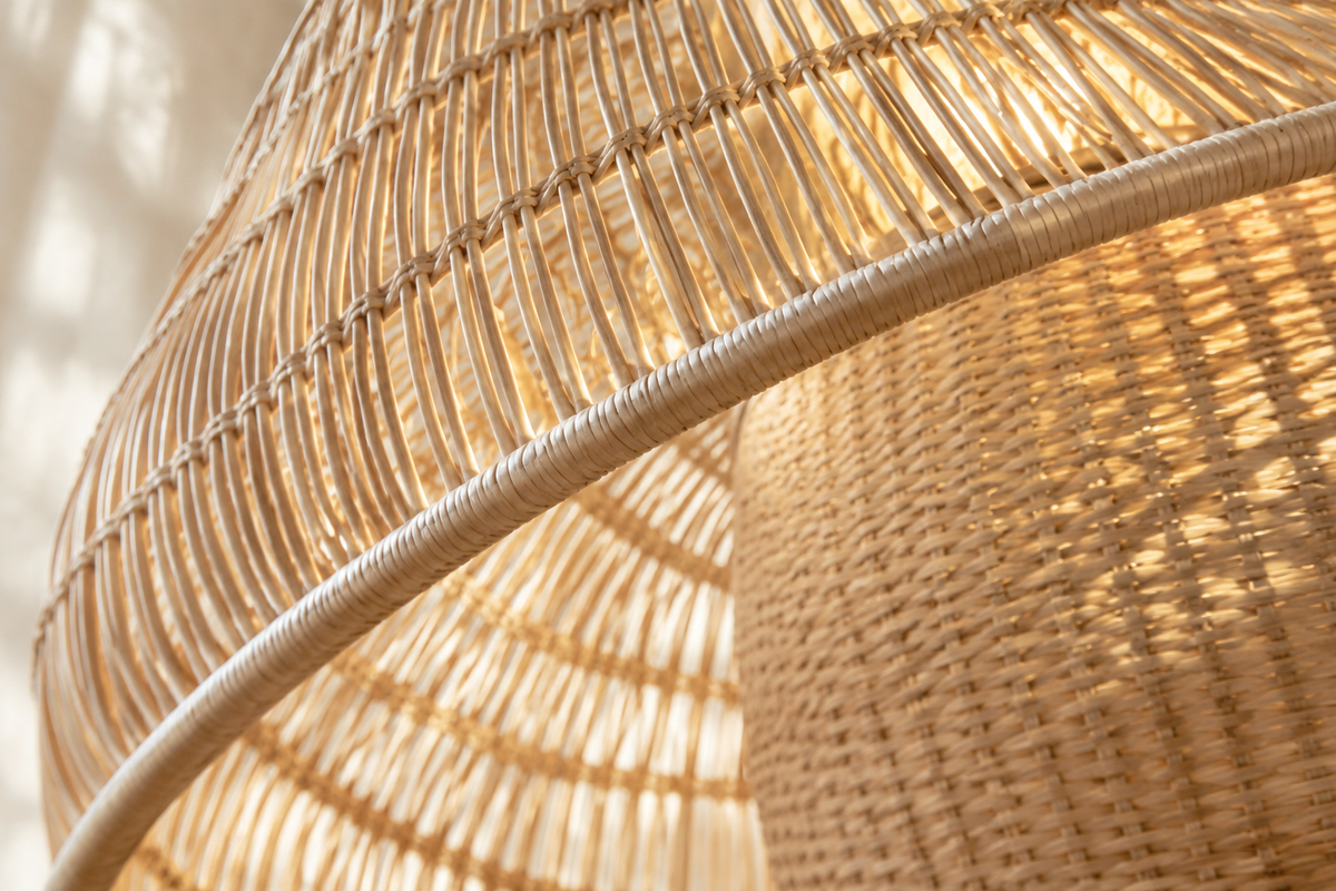 Natural rattan floor lamp beside a sofa