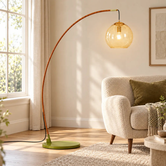 Amber glass arc floor lamp beside a reading chair in a bright living room