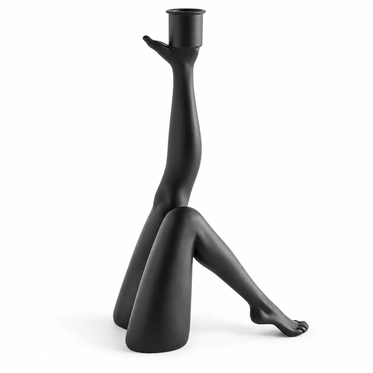 Black kicking-leg sculptural figurine candle holder on white background