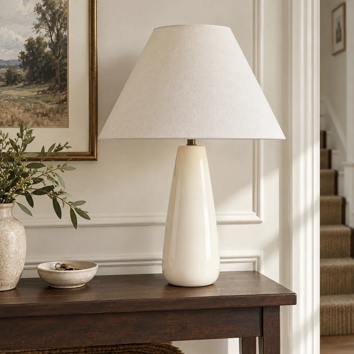 Ceramic white tapered table lamp on a hallway console