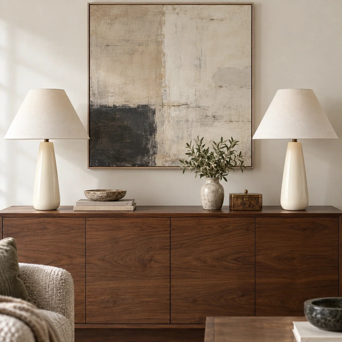 Pair of ceramic white tapered table lamps on a wide sideboard