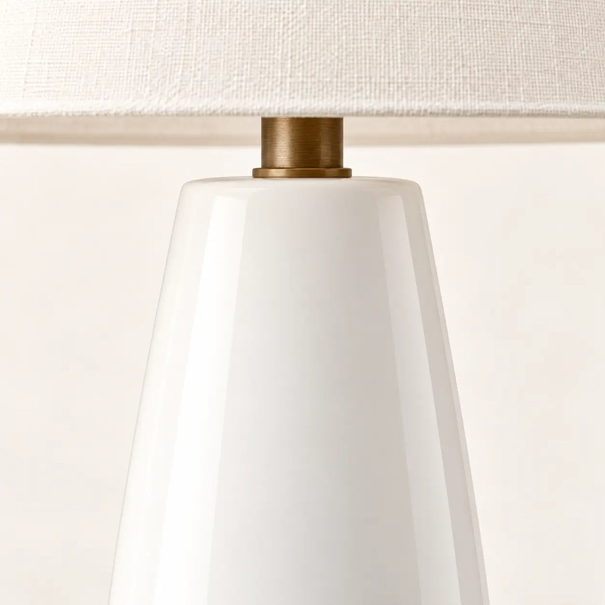 Glossy white ceramic tapered table lamp base detail